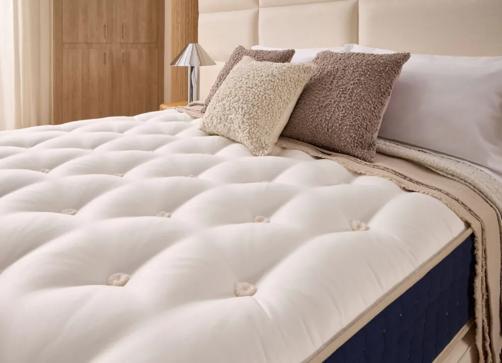 Close up of Grand Luxe Winstons mattress with white tufted sleeping surface from www.winstonsbeds.com/en-us